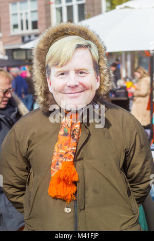 Thomsonlaan, The Hague, the Netherlands -27 April 2017: person wearing a Dutch King Willem-Alexander face mask on Kingsday at a street flea market Stock Photo