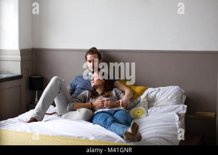 Young couple having coffee in bed Stock Photo