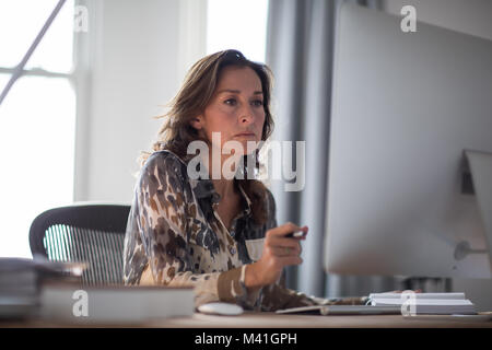 Mature businesswoman working on computer Stock Photo