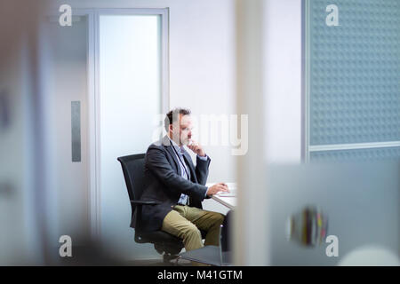 Male Medical Doctor working in his office Stock Photo