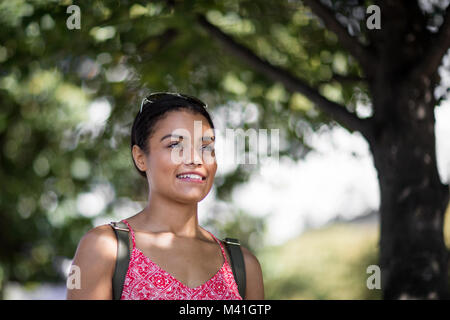 Young adult female walking outdoors Stock Photo