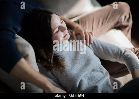 Couple relaxing on sofa together Stock Photo