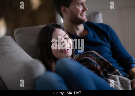 Couple relaxing on sofa together Stock Photo