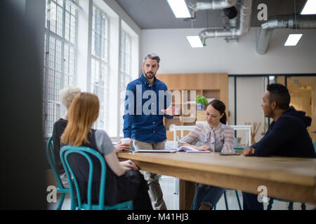 Businessman leading a meeting in creative office Stock Photo