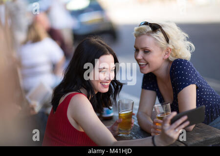 Tourists taking a selfie in a London Pub Stock Photo