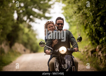 Young couple on motorbike together Stock Photo
