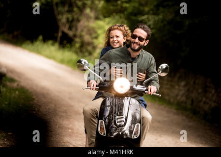 Young couple on motorbike together Stock Photo