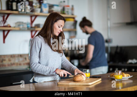 Young couple preparing breakfast together Stock Photo