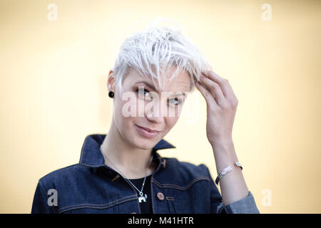 Young adult with hands in hair Stock Photo