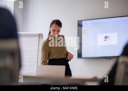 Female business executive setting up a presentation Stock Photo