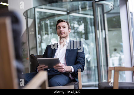 Businessman waiting in office reception Stock Photo