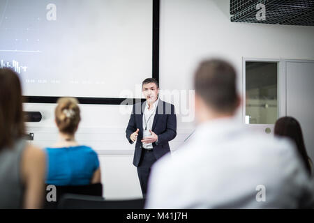 Speaker at a business training conference taking a question Stock Photo