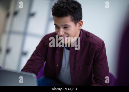 Student working on a laptop at college Stock Photo