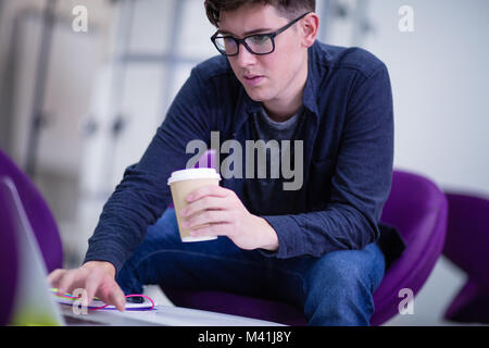 Student working on a laptop at college Stock Photo