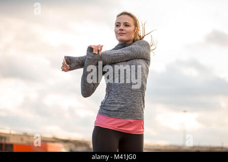 Young adult female stretching before a run Stock Photo