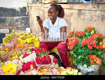 NAIROBI, KENYA-FEBRUARY 5, 2014:  Unidentified black woman sells flowers at old market in centre of Nairobi on February 9, 2014.  Africa. Stock Photo