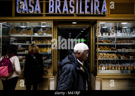 A man walks past a bakery in Lisbon, Portugal. Stock Photo