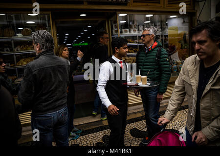 Waiter at a bakery in Lisbon, Portugal. Stock Photo