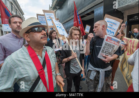 United Voices of the World protesters stand in the road after police have prevented them from protesting on the pavement outside Sotheby's to call for the reinstatement of the 4 workers sacked for protesting for proper sick pay. Stock Photo