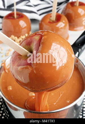 dipping apples in caramel Stock Photo