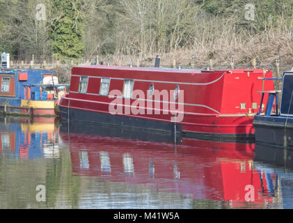 Red Narrowboat Moored on the Staffordshire & Worcestershire Canal, Stourton, South Staffordshire, England, UK in February Stock Photo