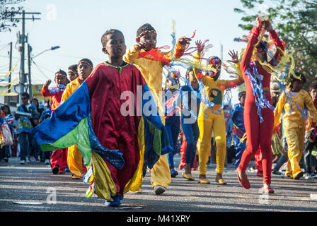 Children wearing colorful costumes and dancing and participating in a parade during the Barranquilla Carnival Stock Photo