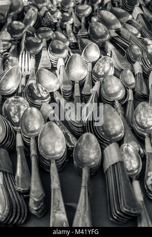 A photo of lots of spoons and cutlery arranged in a pattern on a market stall Stock Photo