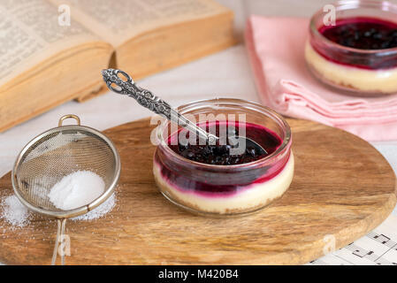 Cheesecake in glass jar with cookies and berries. Stock Photo
