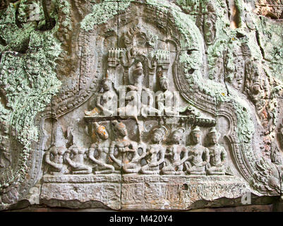 Ancient carving on the wall of Prasat Ta Prum Temple in Siem Reap, Cambodia. Stock Photo