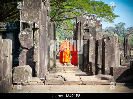 ANGKOR WAT, CAMBODIA - NOV 21,2013: Buddhist monks in Angkor Wat complex on Nov 21, 2013.Cambodia. Angkor Wat was first a Hindu, then subsequently, a  Stock Photo