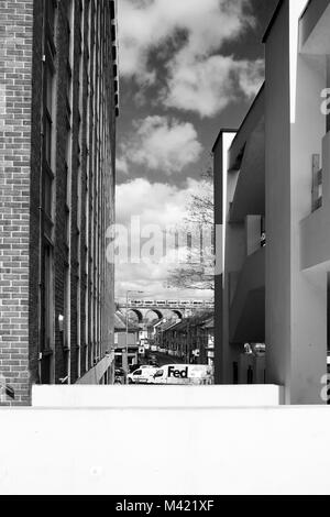 Black and white photograph of Brighton city centre, at the bottom of the photograph is a white wall, on the left if the tall shape of a white concrete Stock Photo