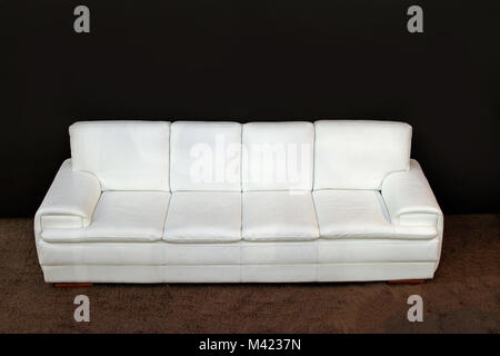 Modern white leather sofa on brown carpet Stock Photo