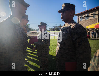 U.S. Marine Cpl. Tyler Foutz, a heavy equipment operator with Combat Logistics Battalion 1, Combat Logistics Regiment 1, 1st Marine Logistics Group, is awarded the Marine of the Year award by Brig. Gen Stephen Sklenka, the commanding general for the 1st MLG, during a quarterly awards ceremony at Camp Pendleton, Calif., Feb. 8, 2018. The awards are given to the Marines and Sailors to recognize the accomplishments achieved by individuals in their respective job fields. (U.S. Marine Corps photo by Cpl. Adam Dublinske) Stock Photo