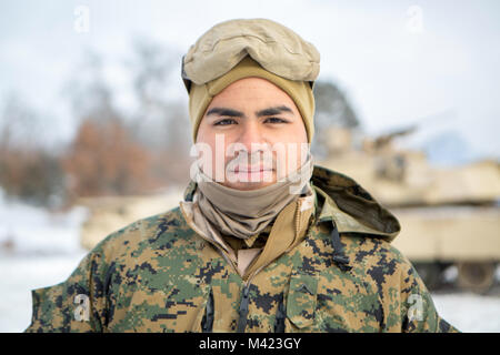 Lance Cpl. William Vasquez is a Sanford, North Carolina, native and Reserve Marine with Company F, 4th Tank Battalion, 4th Marine Division. Vasquez, a tank crew member, participated in exercise Winter Break 2018 on Camp Grayling, Michigan, Feb. 4-17, 2018. When he's not conducting Marine Corps training, Vasquez is a construction worker for Parkers Stockstill Construction in North Carolina.    “This cold weather training really benefits us because we're definitely not used to being in this type of environment,” said Vasquez. “This training is helping us get adjusted to the temperatures that we' Stock Photo