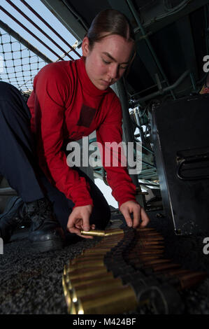 180209-N-NB544-027 GULF OF THAILAND (Feb. 9, 2018) Gunner's Mate Seaman Bianca Yorga, center, from Vista, Calif., connects rounds of .50-caliber machine gun ammunition during small craft action team (SCAT) training aboard the amphibious assault ship USS Bonhomme Richard (LHD 6). Bonhomme Richard is operating in the Indo-Asia-Pacific region as part of a regularly scheduled patrol and provides a rapid-response capability in the event of a regional contingency or natural disaster. (U.S. Navy photo by Mass Communication Specialist 2nd Class Kyle Carlstrom/Released) Stock Photo