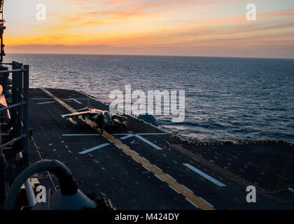 ATLANTIC OCEAN (Feb. 9, 2018) An AV-8B Harrier II jet, attached to Marine Medium Tiltrotor Squadron 162, takes off from the flight deck on the amphibious assault ship USS Iwo Jima (LHD 7). The Iwo Jima Amphibious Ready Group (ARG) is deployed in support of maritime security operations and theater security cooperation efforts in Europe and the Middle East. The Iwo Jima ARG embarks the 26th Marine Expeditionary Unit and includes Iwo Jima, the amphibious transport dock ship USS New York (LPD 21), the dock landing ship USS Oak Hill (LSD 51), Fleet Surgical Team 8, Helicopter Sea Combat Squadron 28 Stock Photo
