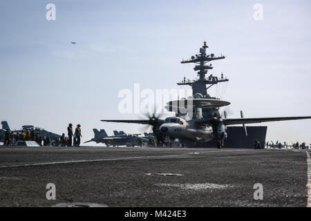 180210-N-VN584-1035 ARABIAN GULF (Feb. 10, 2018) An E-2C Hawkeye, assigned to the Sunkings of Carrier Airborne Early Warning Squadron (VAW) 116, readies for launch on the flight deck of the aircraft carrier USS Theodore Roosevelt (CVN 71). Theodore Roosevelt and its carrier strike group are deployed to the U.S. 5th Fleet area of operations in support of maritime security operations to reassure allies and partners and preserve the freedom of navigation and the free flow of commerce in the region. (U.S. Navy photo by Mass Communication Specialist 3rd Class Alex Corona/Released) Stock Photo