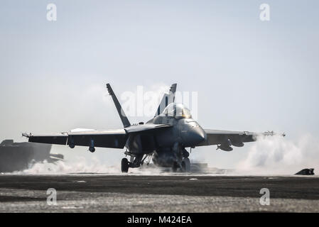 180210-N-VN584-1200 ARABIAN GULF (Feb. 10, 2018) An F/A-18F Super Hornet, assigned to the Fighting Redcocks of Strike Fighter Attack Squadron (VFA) 22, launches from the flight deck of the aircraft carrier USS Theodore Roosevelt (CVN 71). Theodore Roosevelt and its carrier strike group are deployed to the U.S. 5th Fleet area of operations in support of maritime security operations to reassure allies and partners and preserve the freedom of navigation and the free flow of commerce in the region. (U.S. Navy photo by Mass Communication Specialist 3rd Class Alex Corona/Released) Stock Photo