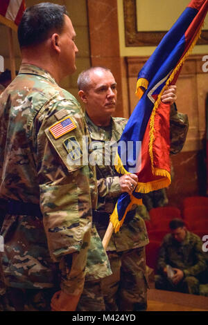 Brig. Gen. Gordon L. Ellis receives the 38th Infantry Division flag during the unit’s change of command ceremony in Indianapolis, Sunday, Feb. 11, 2018. “As I assume command, I am cognizant of the need to continue to build sustained readiness across the formation of this division,” said Ellis during his speech. Photo by Sgt. Diana Richardson, 38th Infantry Division Unit Public Affairs Representative Stock Photo