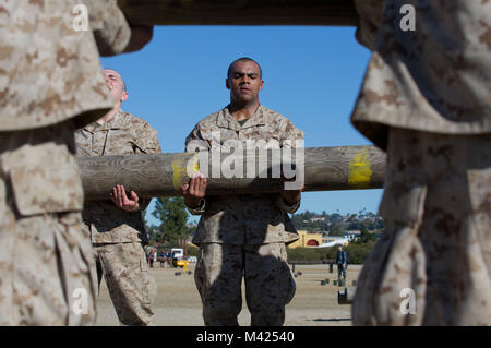 Recruits with Kilo Company, 3rd Recruit Training Battalion, perform log drills at Marine Corps Recruit Depot San Diego, Jan. 22. The recruits had to hold the log as a team for the entire session, which lasted for approximately an hour. Annually, more than 17,000 males recruited from the Western Recruiting Region are trained at MCRD San Diego. Kilo Company is scheduled to graduate March 16. Stock Photo