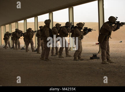 U.S. Marines with Headquarters and Support Company, Ground Combat Element, Special Purpose Marine Air-Ground Task Force – Crisis Response – Central Command conduct shooting drills during a combat marksmanship program live-fire range, Jan. 23, 2018. The purpose of the training was to increase lethality, solidify warrior ethos, and shoot in a variety of conditions. Stock Photo