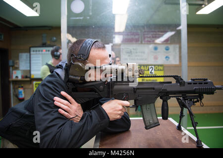 A German Soldier assigned to SHAPE fires with his Heckler and Koch G36K A4 rifle, on Chièvres Air Base, Belgium, Jan. 24, 2018. (U.S. Army photo by Visual Information Specialist Pierre-Etienne Courtejoie) Stock Photo