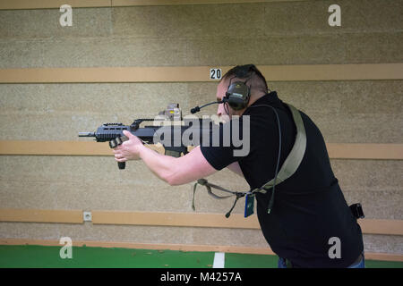 A German Soldier assigned to SHAPE fires with his Heckler and Koch G36K A4 rifle, on Chièvres Air Base, Belgium, Jan. 24, 2018. (U.S. Army photo by Visual Information Specialist Pierre-Etienne Courtejoie) Stock Photo