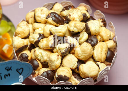 many mini chocolate eclairs with lined slide in plate, festive Candy Bar Stock Photo