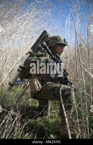 U.S. Marine Corps Lance Cpl. Brian Sanchezangel, rifleman, Kilo Company, Battalion Landing Team (BLT), 3rd Battalion, 1st Marine Regiment awaits the order to push forward during an assault exercise on Camp Pendleton, California, Jan. 31, 2018. In addition to refining command and control procedures, BLT 3/1 validated their ability to conduct raids from air and mechanized platforms. (U.S. Marine Corps photo by Cpl. Danny Gonzalez) Stock Photo
