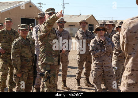 TAJI MILITARY COMPLEX, Iraq - U.S. Army Base Operations Support-Integrator Commander Lt. Col Mark Turner, orients soldiers assigned to the Spanish army to their potential aviation operations area during their inaugural reconnaissance visit at Camp Taji, Iraq, Feb. 1, 2018. The Spanish army will integrate with the 449th Combat Aviation Brigade to augment aviation operations as part of the overall Combined Joint Task Force-Operation Inherent Resolve building partner capacity mission which focuses on training and improving the capability of partnered forces fighting ISIS. CJTF-OIR is the global C Stock Photo