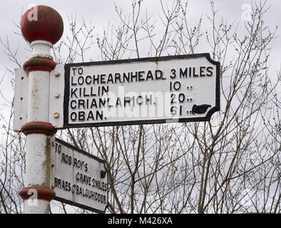 Fingerpost sign directing travellers towards Rob Roy's Grave or towards Lochearnhead, Balquhidder, Perthshire, Scotland, UK. Stock Photo