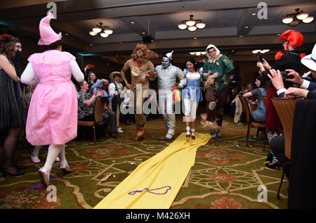 Members of the 81st Medical Operations Squadron portray the cast of The Wizard of Oz as they dance down the aisle during a Mardi Gras float contest at the 30th Annual Krewe of Medics Mardi Gras Ball at the Bay Breeze Event Center Feb. 3, 2018, on Keesler Air Force Base, Mississippi. The Krewe of Medics hosts a yearly ball to give Keesler Medical Center personnel a taste of the Gulf Coast and an opportunity to experience a traditional Mardi Gras. The theme for this year's ball was Read It-Be It. The 81st MDOS won first place in the float contest. (U.S. Air Force photo by Kemberly Groue) Stock Photo