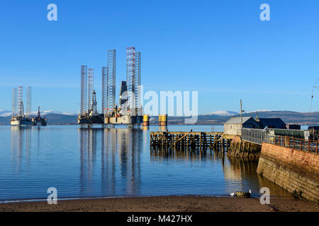 Oil rigs / drilling platforms moored in Cromarty Firth viewed from town of Cromarty on the Black Isle in Ross & Cromarty, Highland Region, Scotland Stock Photo