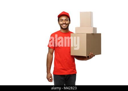 Delivery Concept - Portrait of Happy African American delivery man in red cloth holding a box package. Isolated on white studio Background. Copy Space Stock Photo